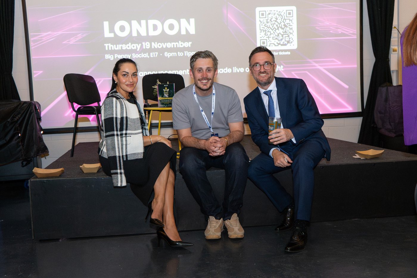 Guests at UK Homes Network LIVE Leeds in front of the screen announcing UKHN LIVE London, Thursday 19 November at Big Penny Social