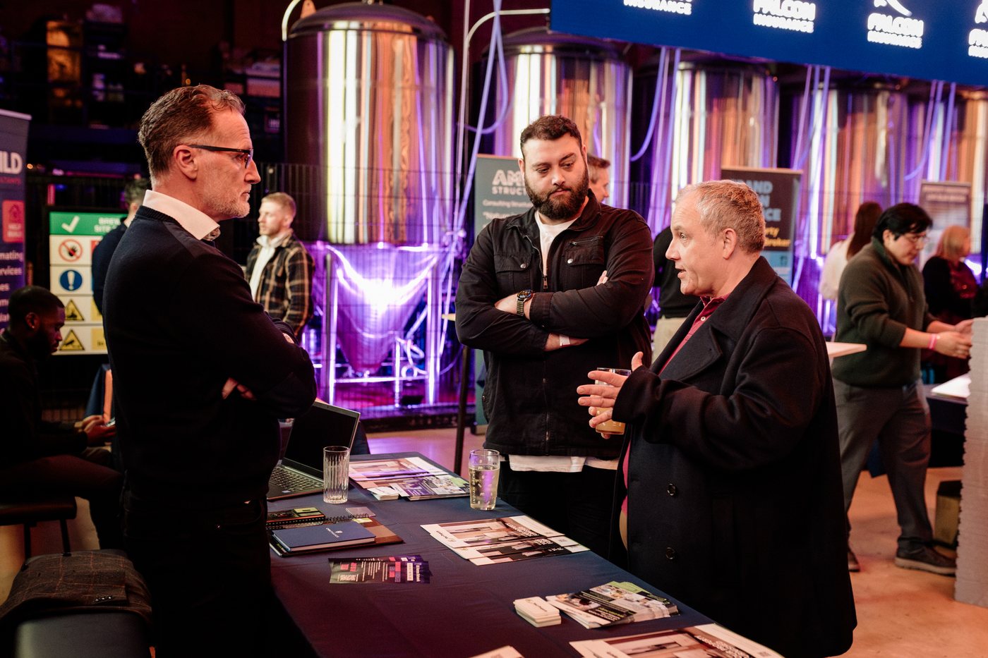 Visitors at an exhibitor table at UK Homes Network LIVE Birmingham