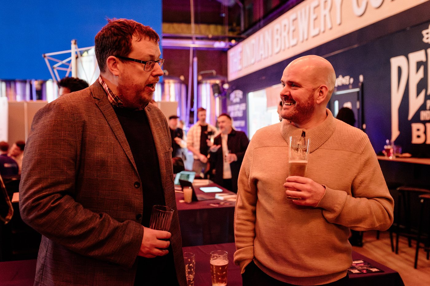 Two guests chatting over a drink at UK Homes Network LIVE Birmingham