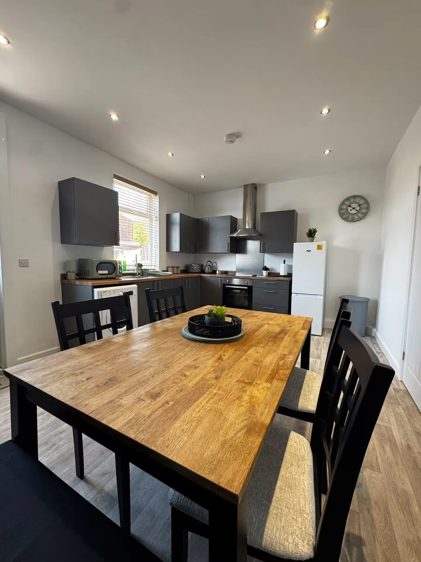 Open-plan kitchen diner with a large oak table at the Flow Stays family home in Hillsborough, Sheffield