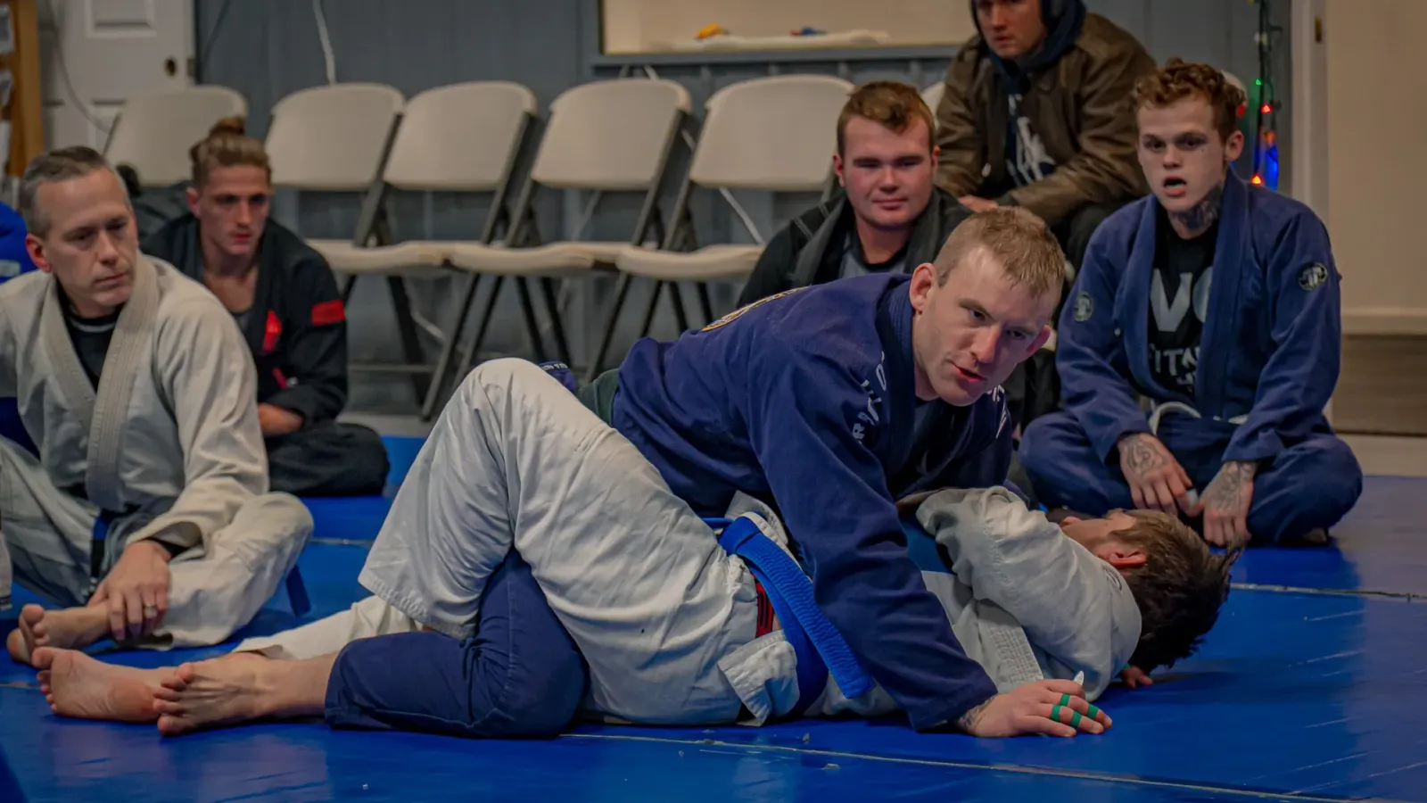 An instructor demonstrating a technique while the class watches during BJJ Fundamentals