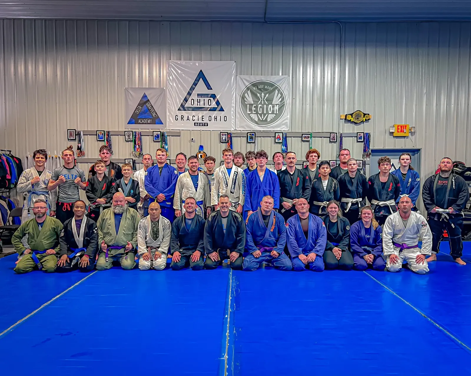 Delta Grappling Academy members and coaches in a group photo under the Gracie Ohio banner