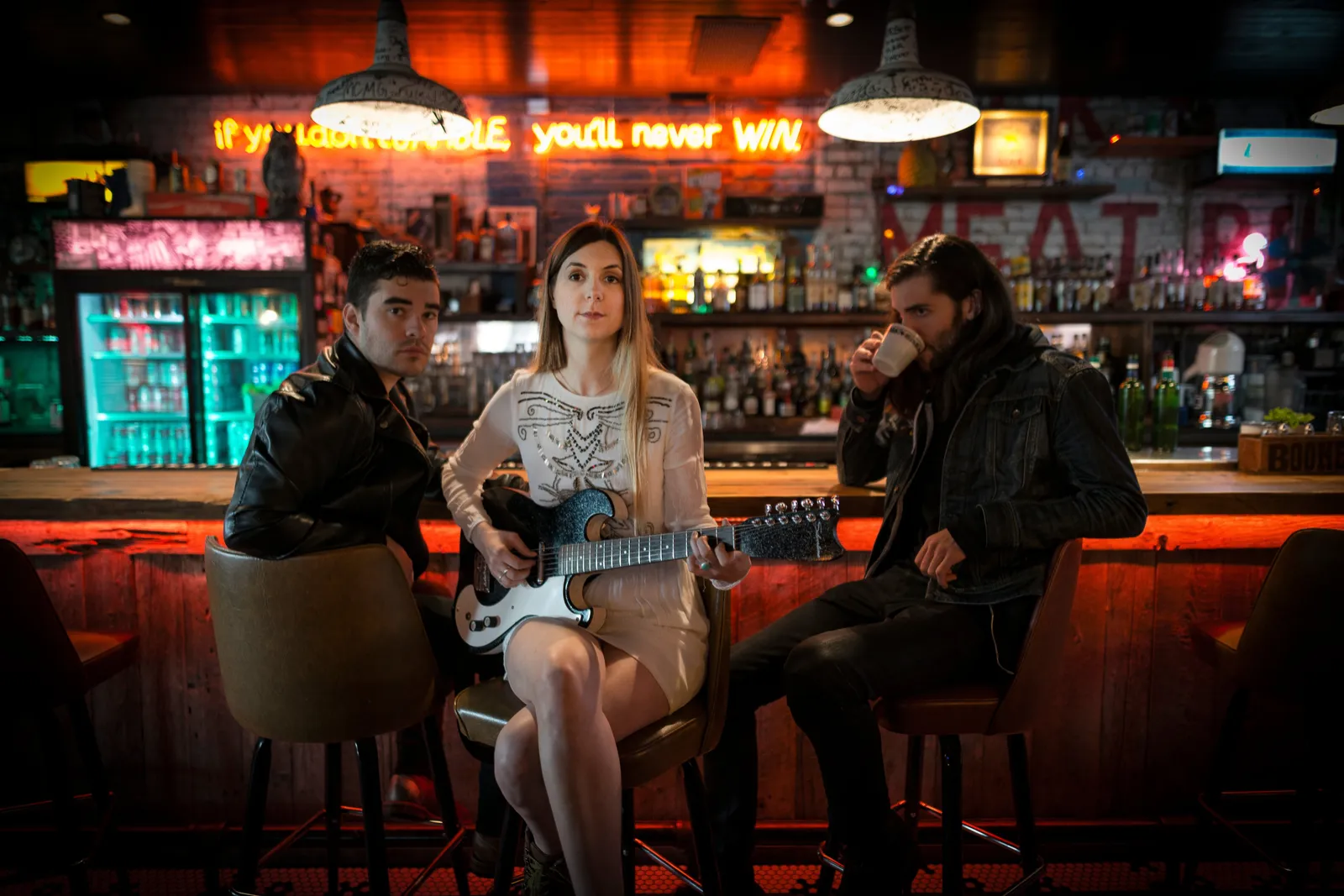 Olivia Street with her guitar, photographed in a bar