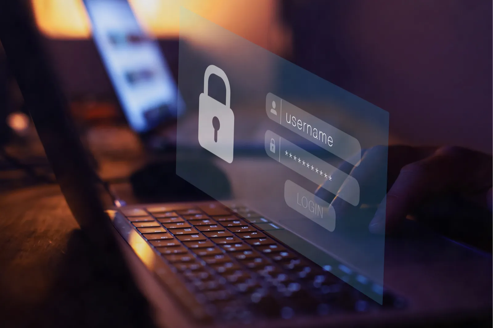 A laptop with a sign-in screen showing a username and hidden password