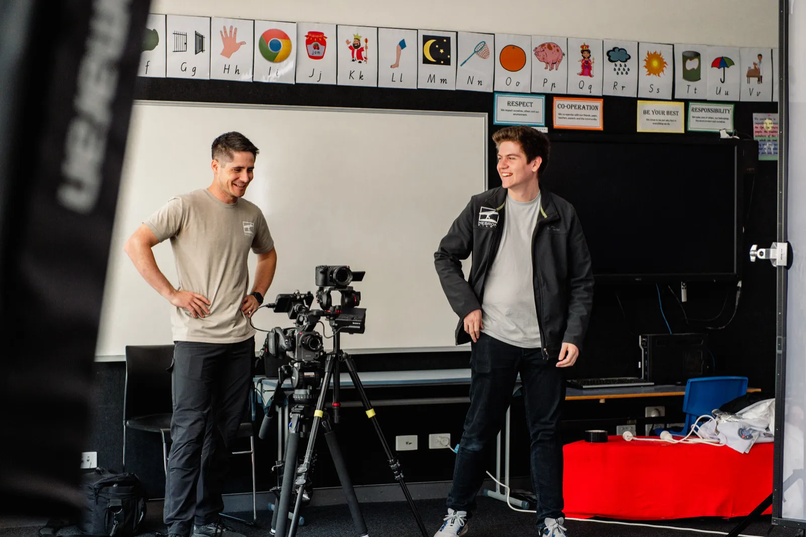 Crew preparing a camera in a classroom for the Passions & Pathways shoot