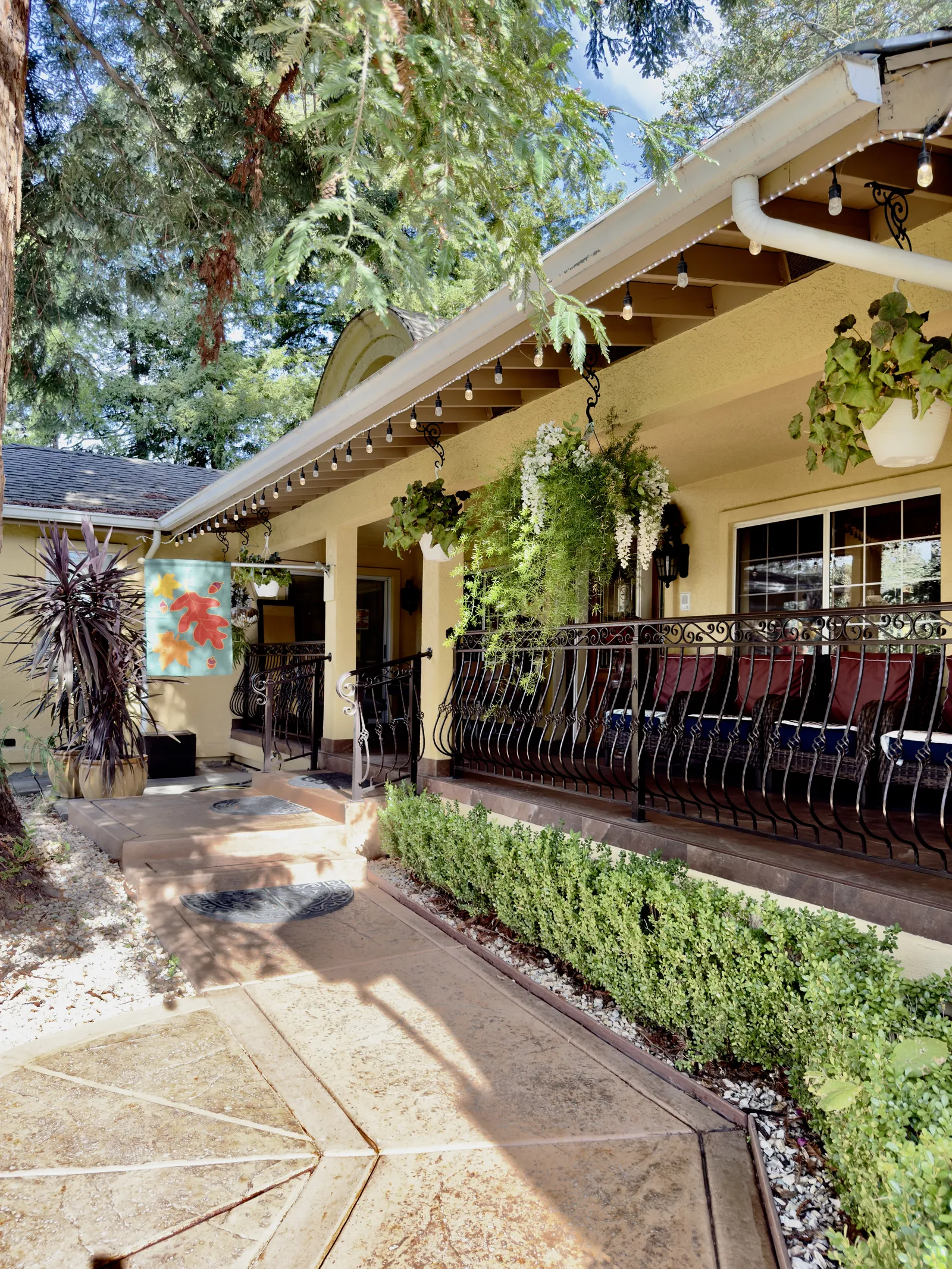 A shaded front porch with seating at Villa Linda