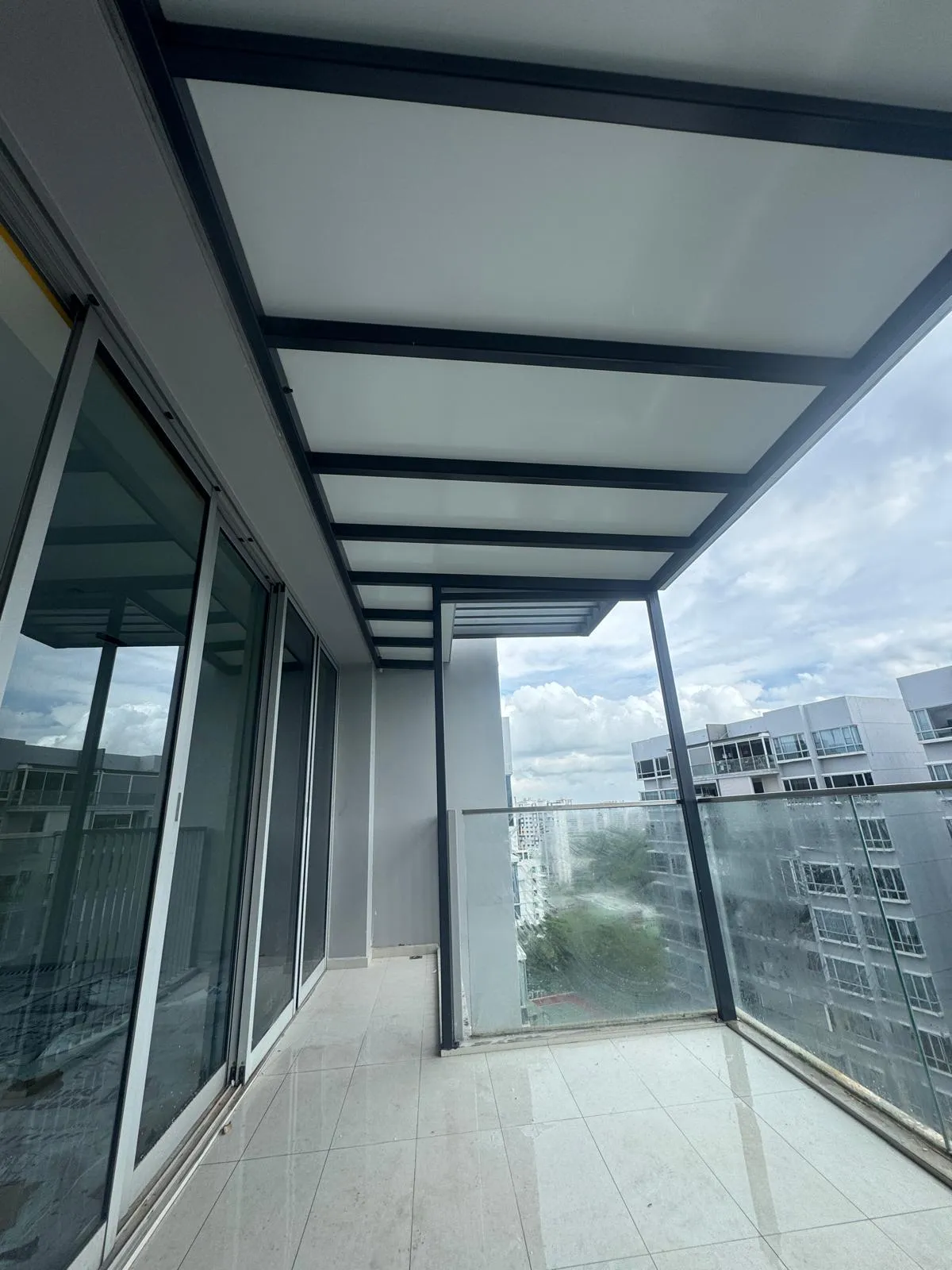 Roof extension on a high-rise balcony seen from below