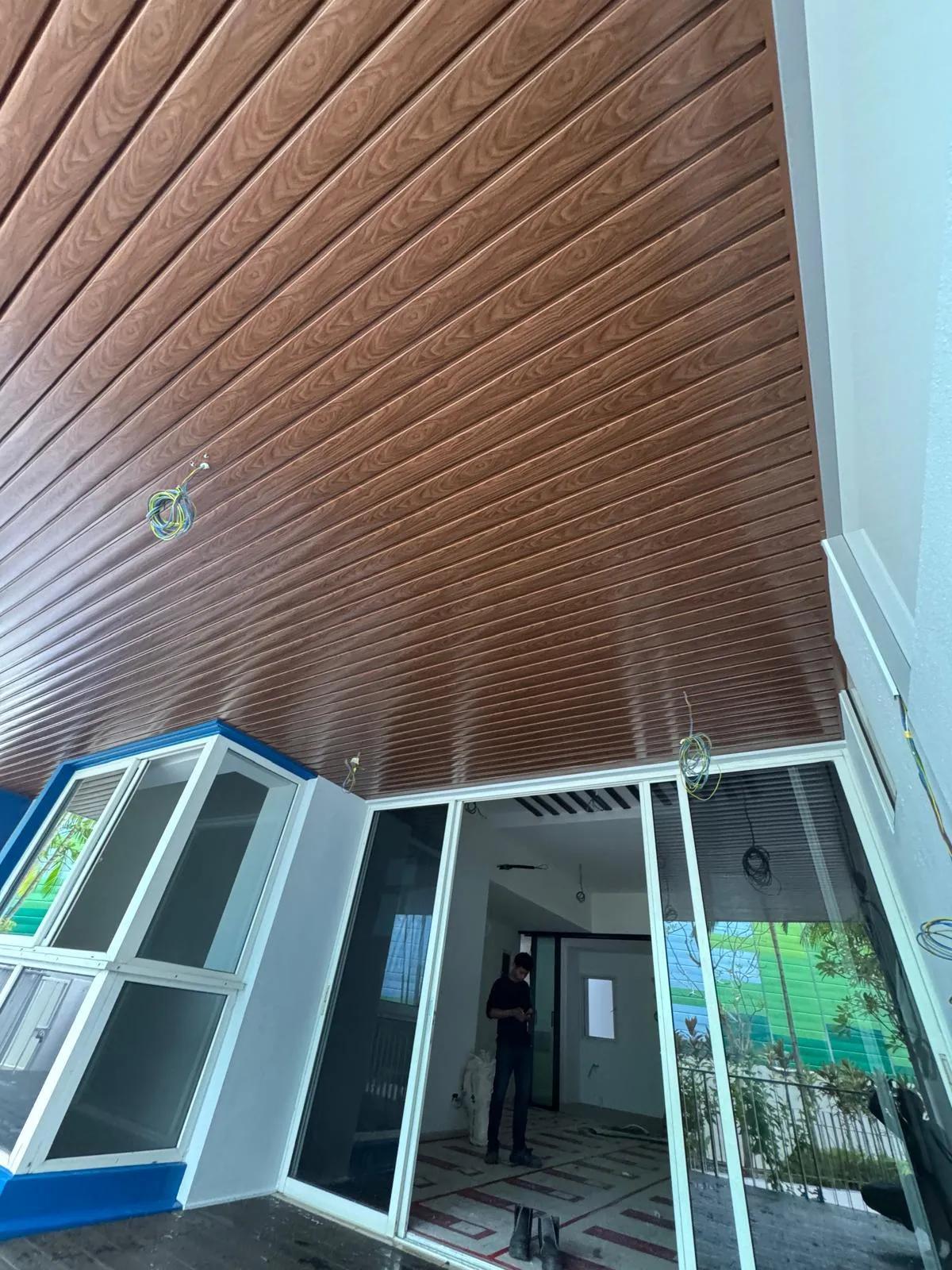 Glazed conservatory under a timber-look ceiling