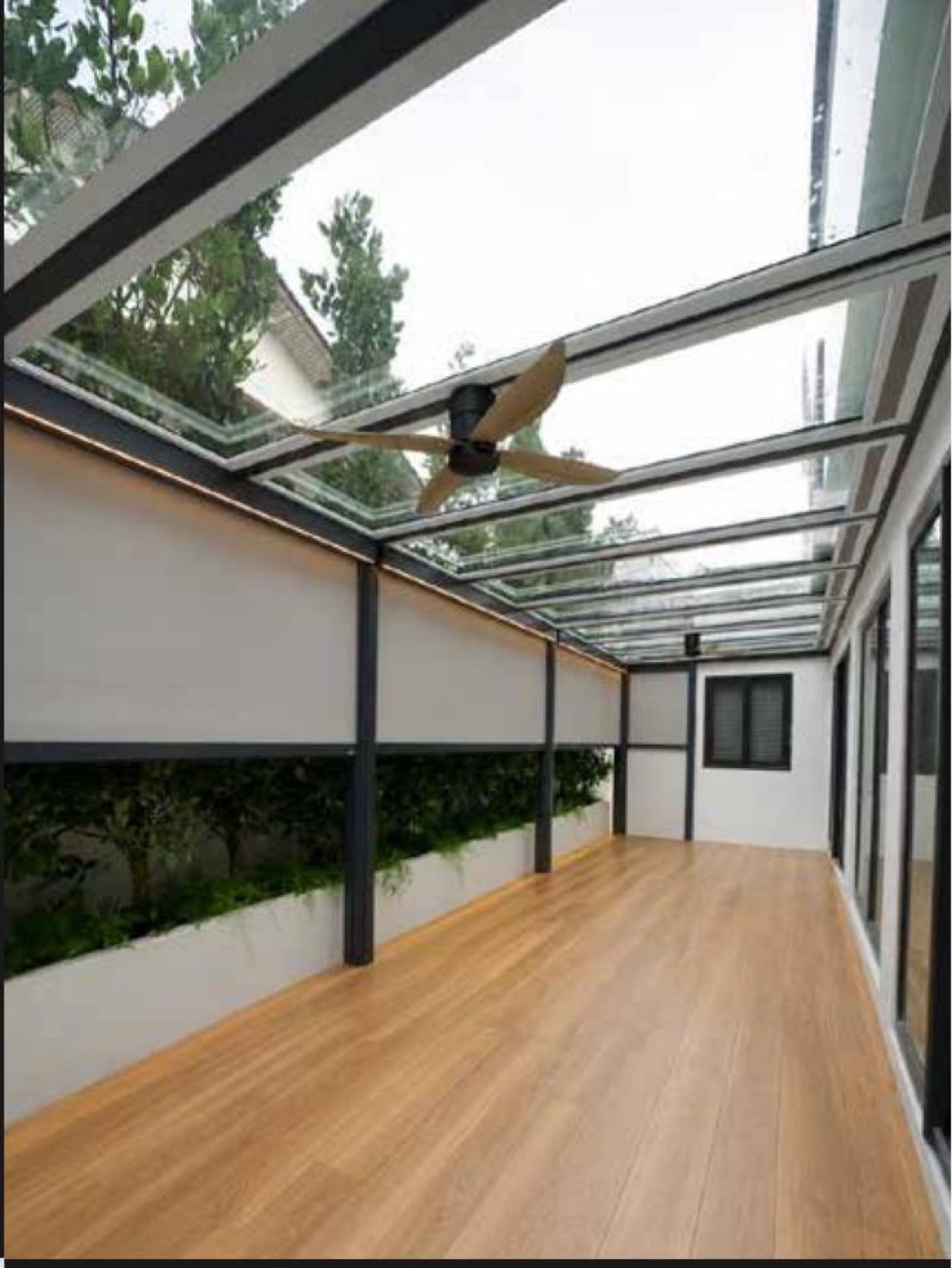 Tempered glass roof over a timber-floored walkway