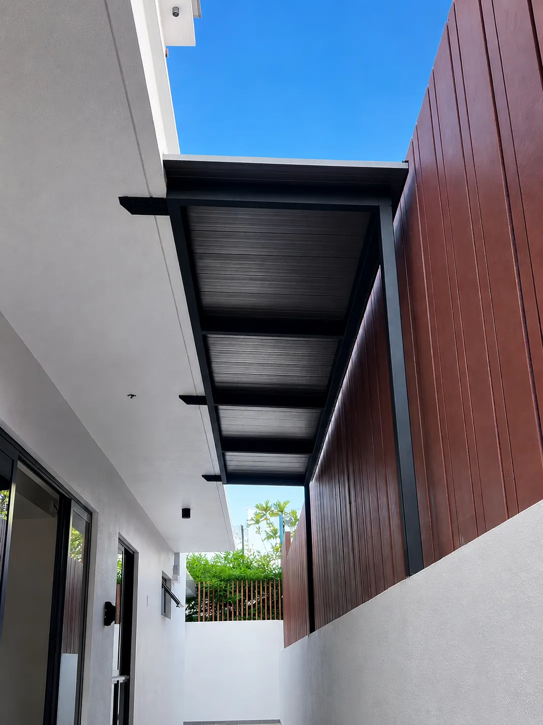 FluteShield fluted panels seen from below along a house wall