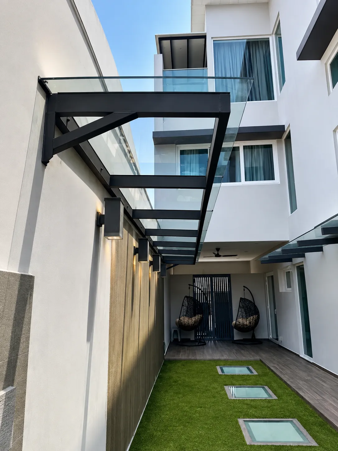Glass awning over a landed home side entrance