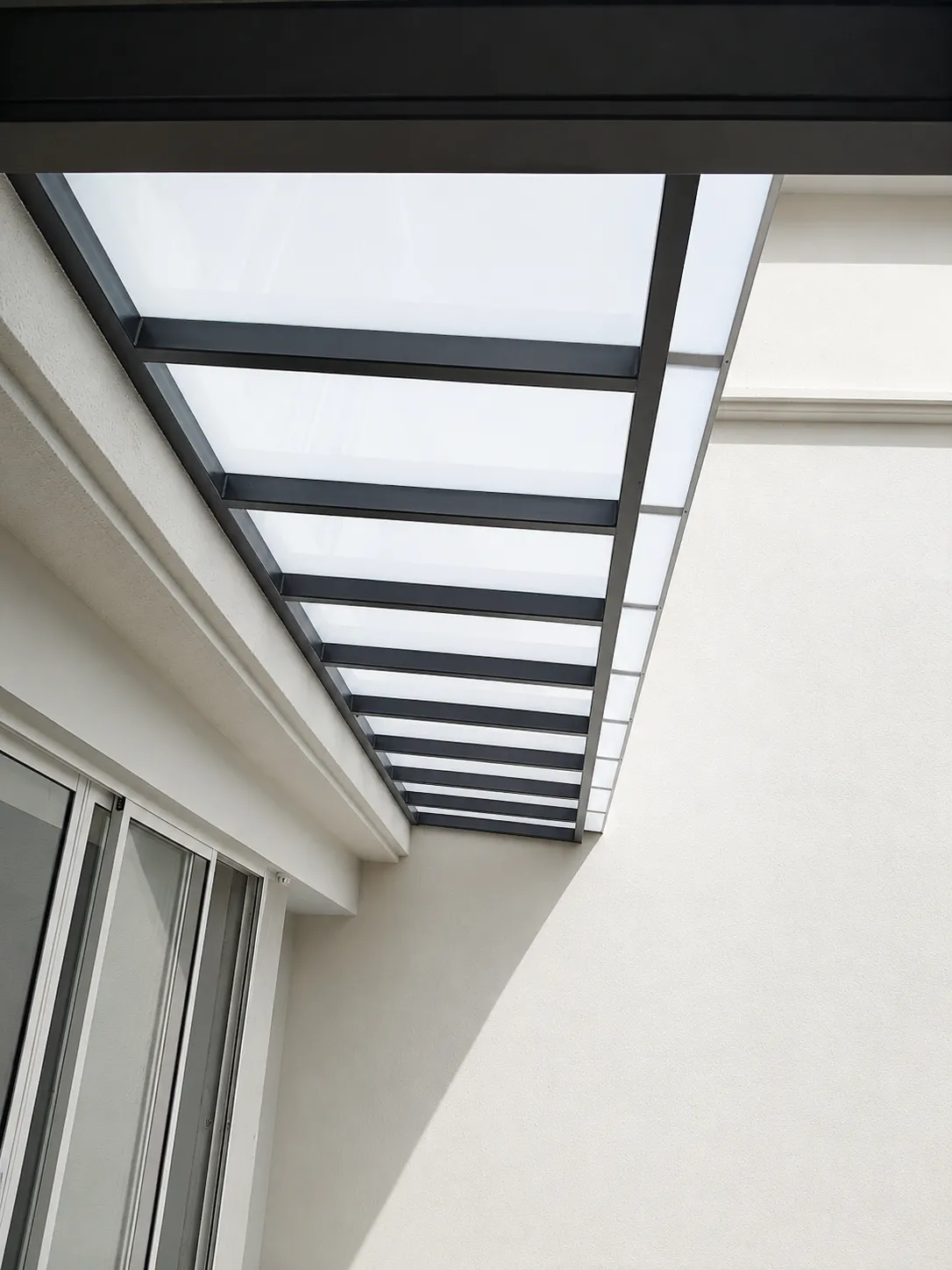 Glass awning running along a boundary wall
