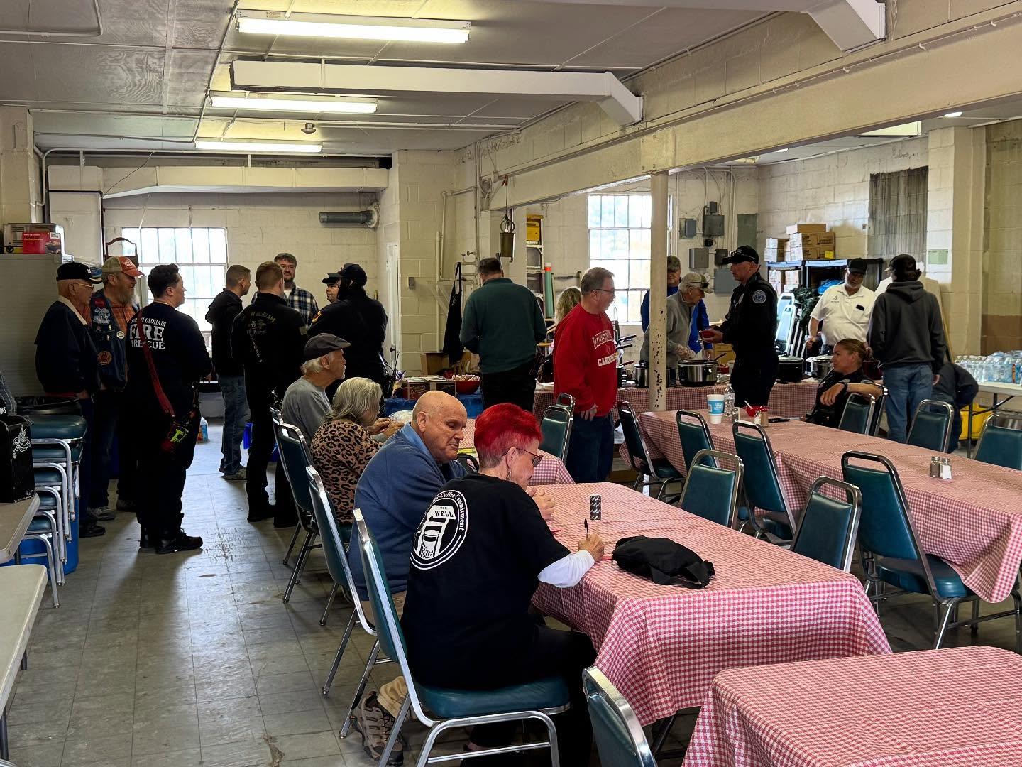 Neighbours at a community dinner in the lodge hall