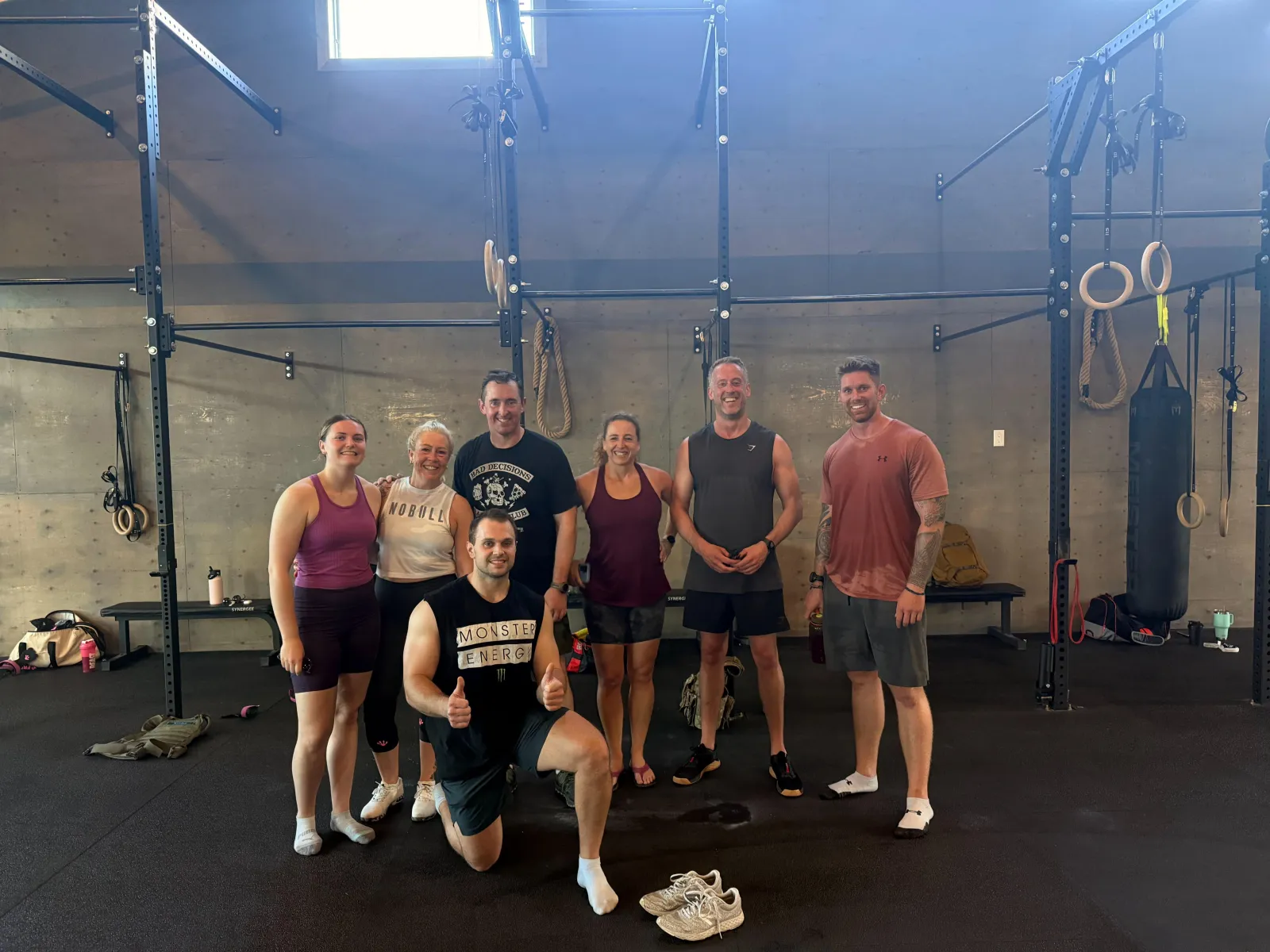 A BTB class of adult members together on the training floor in the barn