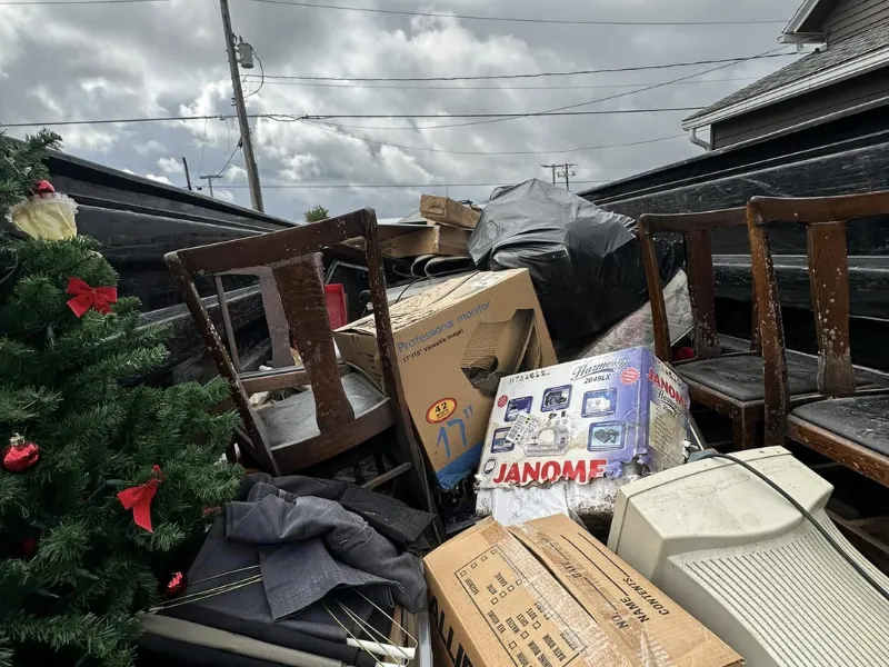 Trailer loaded with old furniture and boxes from a recent junk removal job