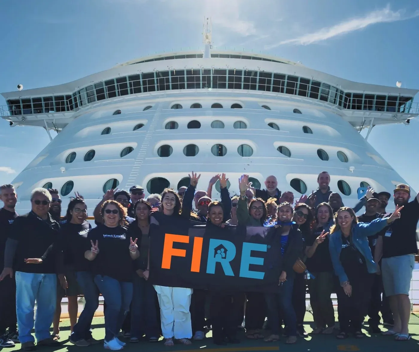 FIRE Center members holding the FIRE banner on the Alaska cruise, 2025
