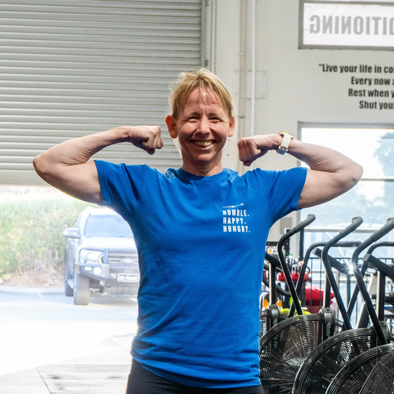 Member flexing and smiling