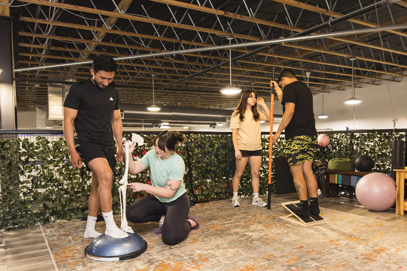 Morgan coaching a group of practitioners through a movement assessment