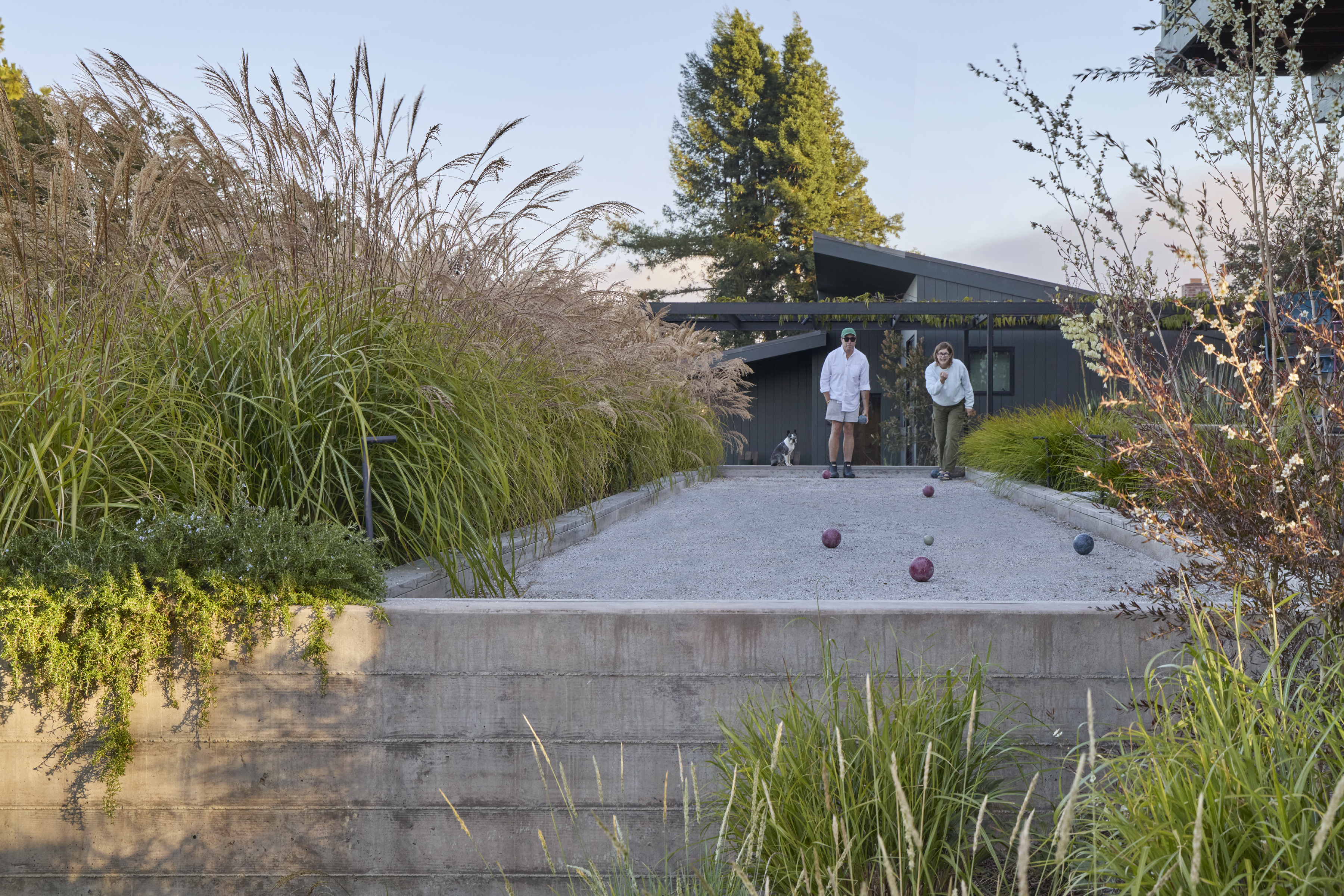 Bocce ball court built in Sebastopol CA by OCL Landscaping with crushed stone surface, concrete curb and ornamental grass borders