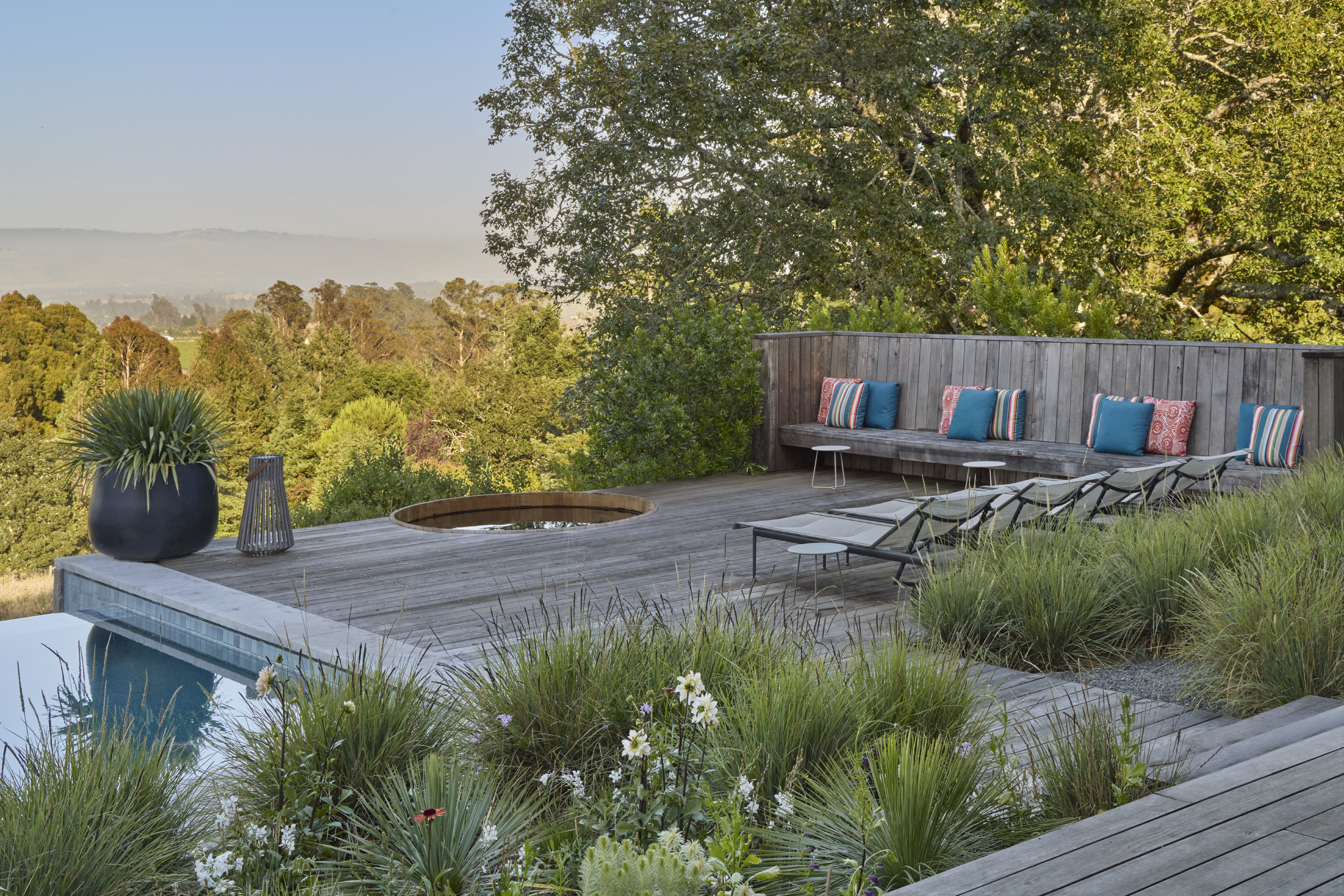 Sunken spa and sun deck with bench seating overlooking the Sonoma County valley