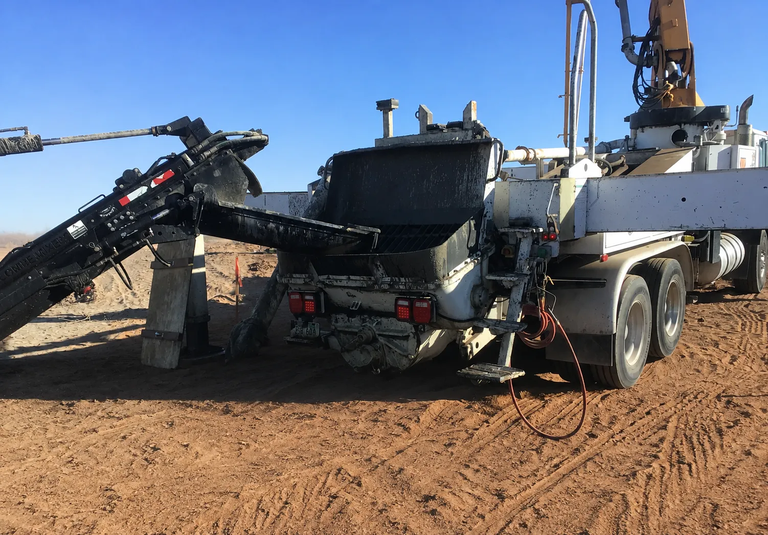 ProMix volumetric mixer truck on a jobsite with the chute extended