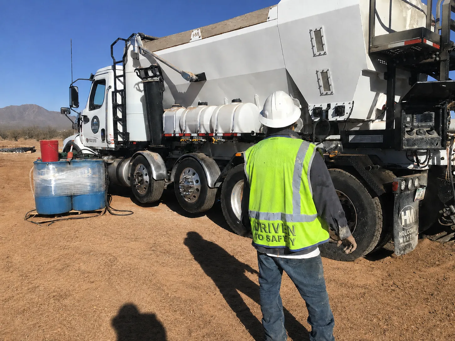ProMix volumetric truck with a crew member in hi-vis on a remote jobsite