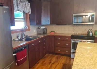 Before: Kitchen with dark stained cabinets before refinishing