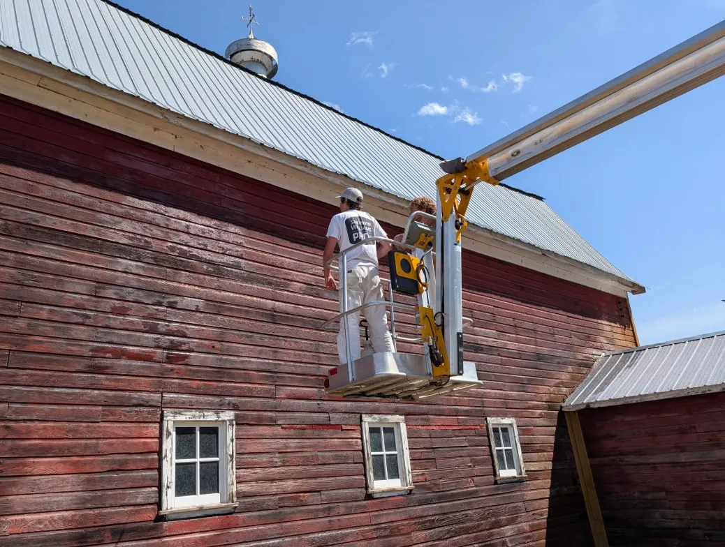 Before: Weathered barn siding during prep before painting