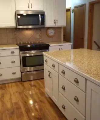After: Kitchen cabinets refinished in bright white