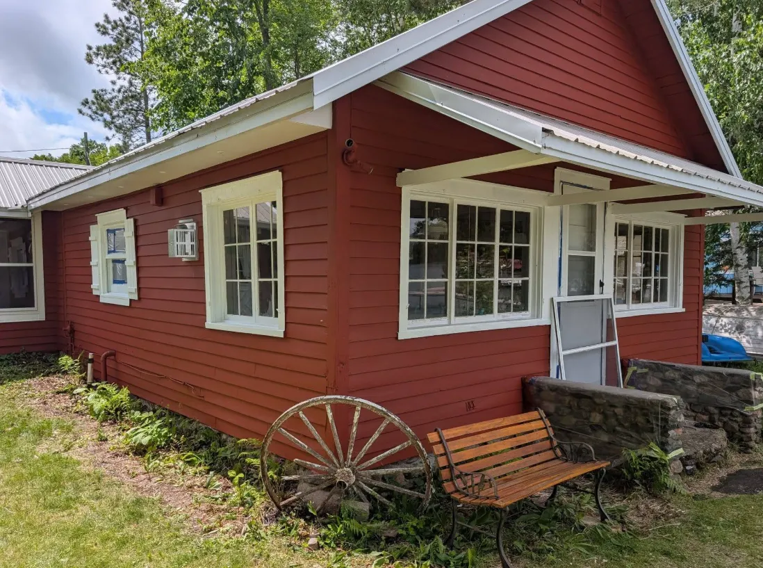 After: Red cabin exterior repainted with fresh white trim