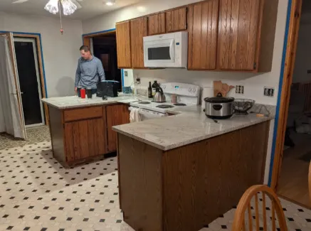 Before: Kitchen with dated oak cabinets before refinishing