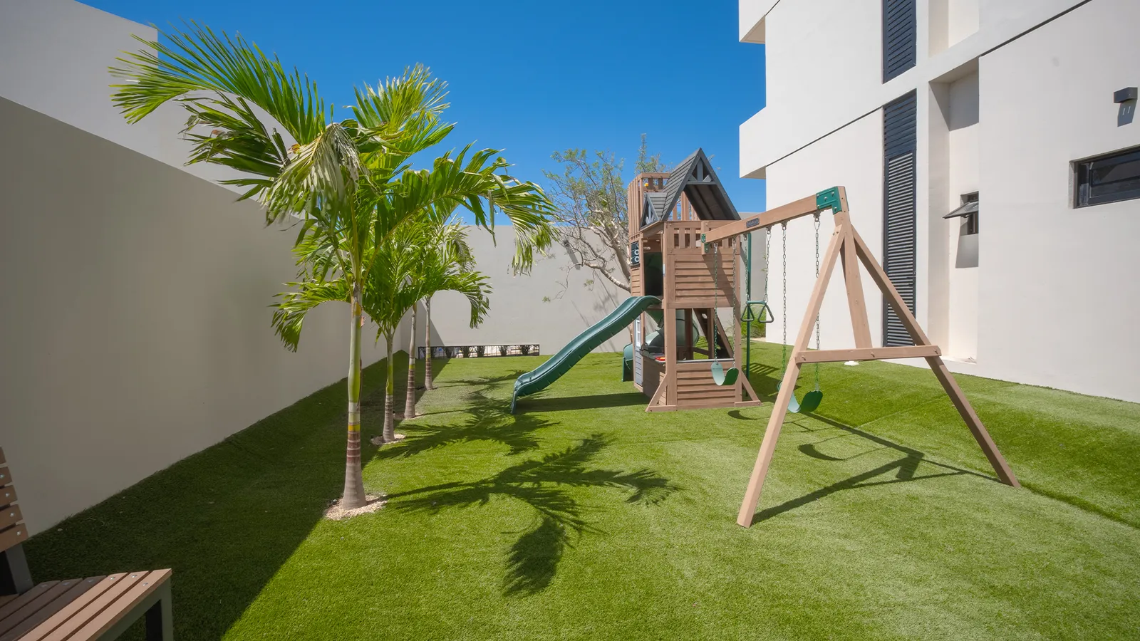 Área de juegos infantiles con pasto