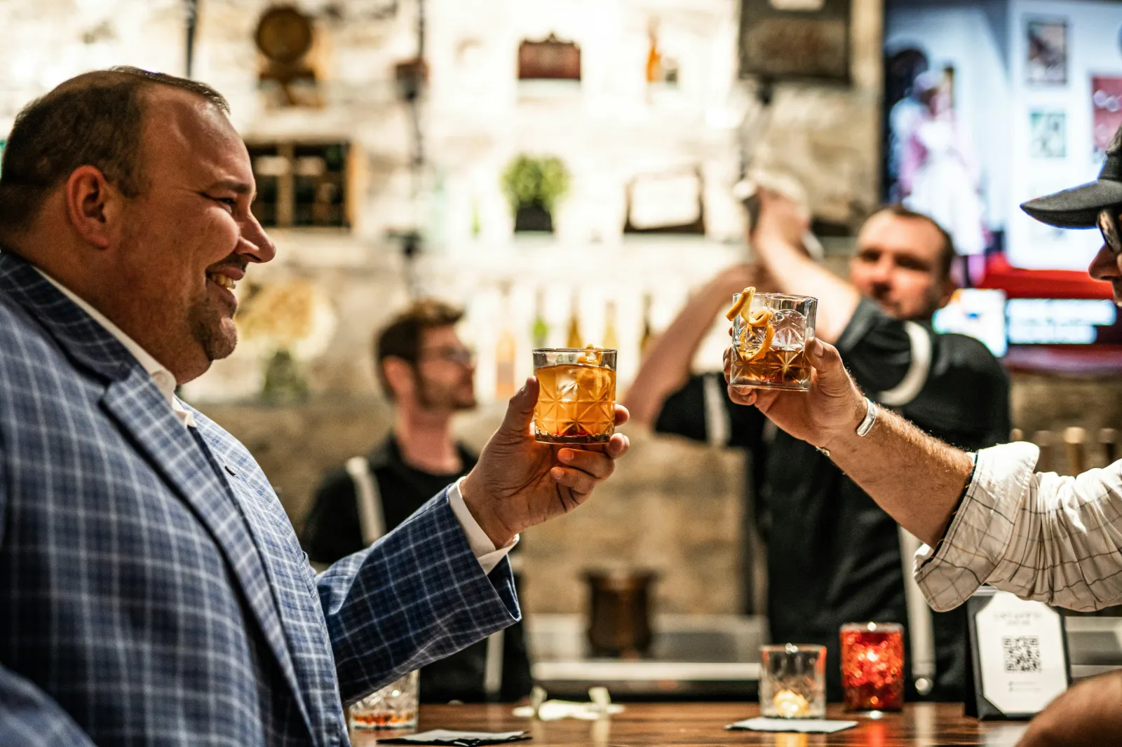 Guests toasting at a Pittsburgh restaurant bar