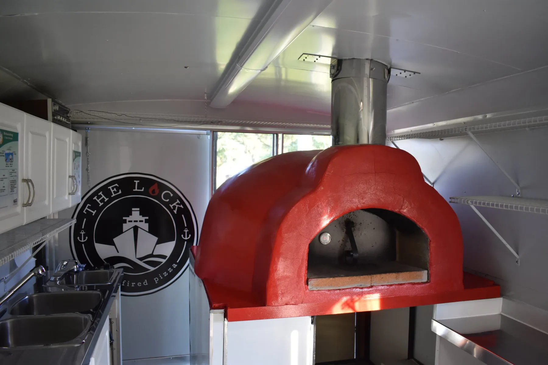 The Lock's red mobile wood-fired pizza oven