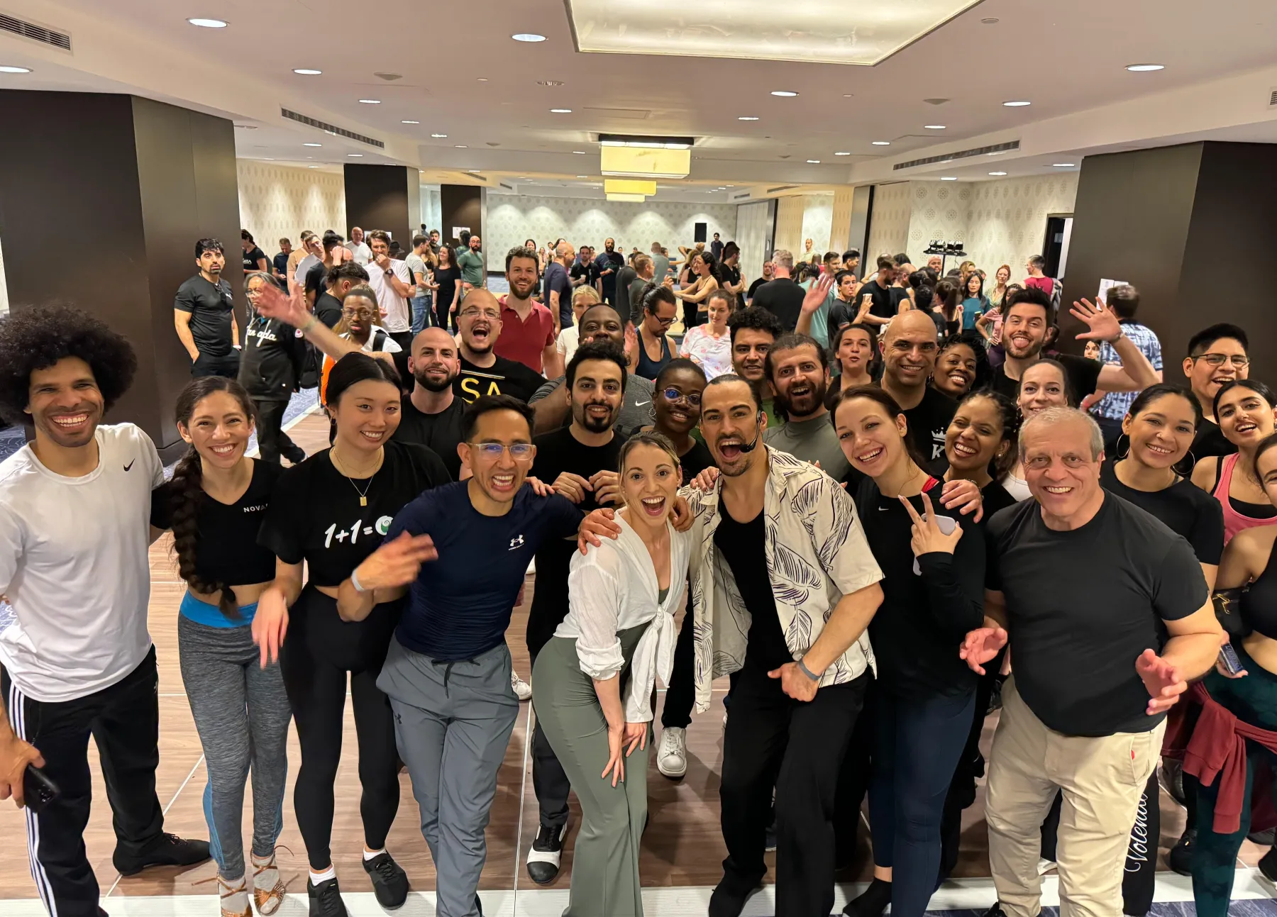 A big group of Salsa with Hunter students smiling together in a New York dance studio
