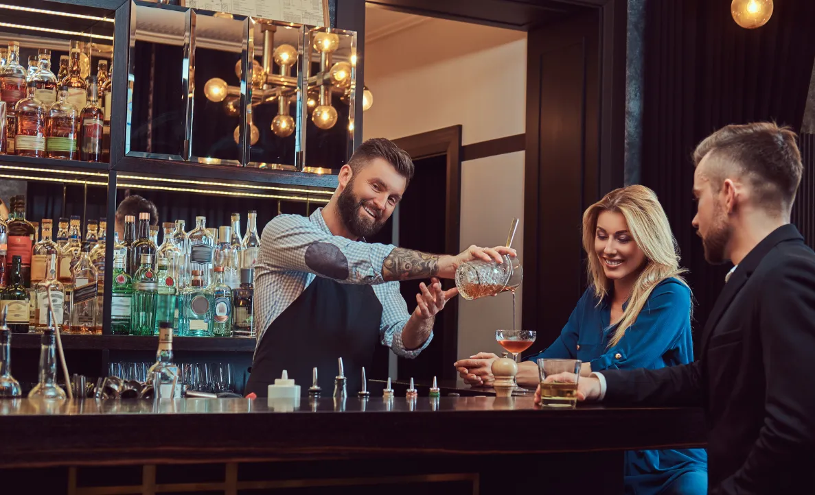 Bartender pouring cocktail at the bar
