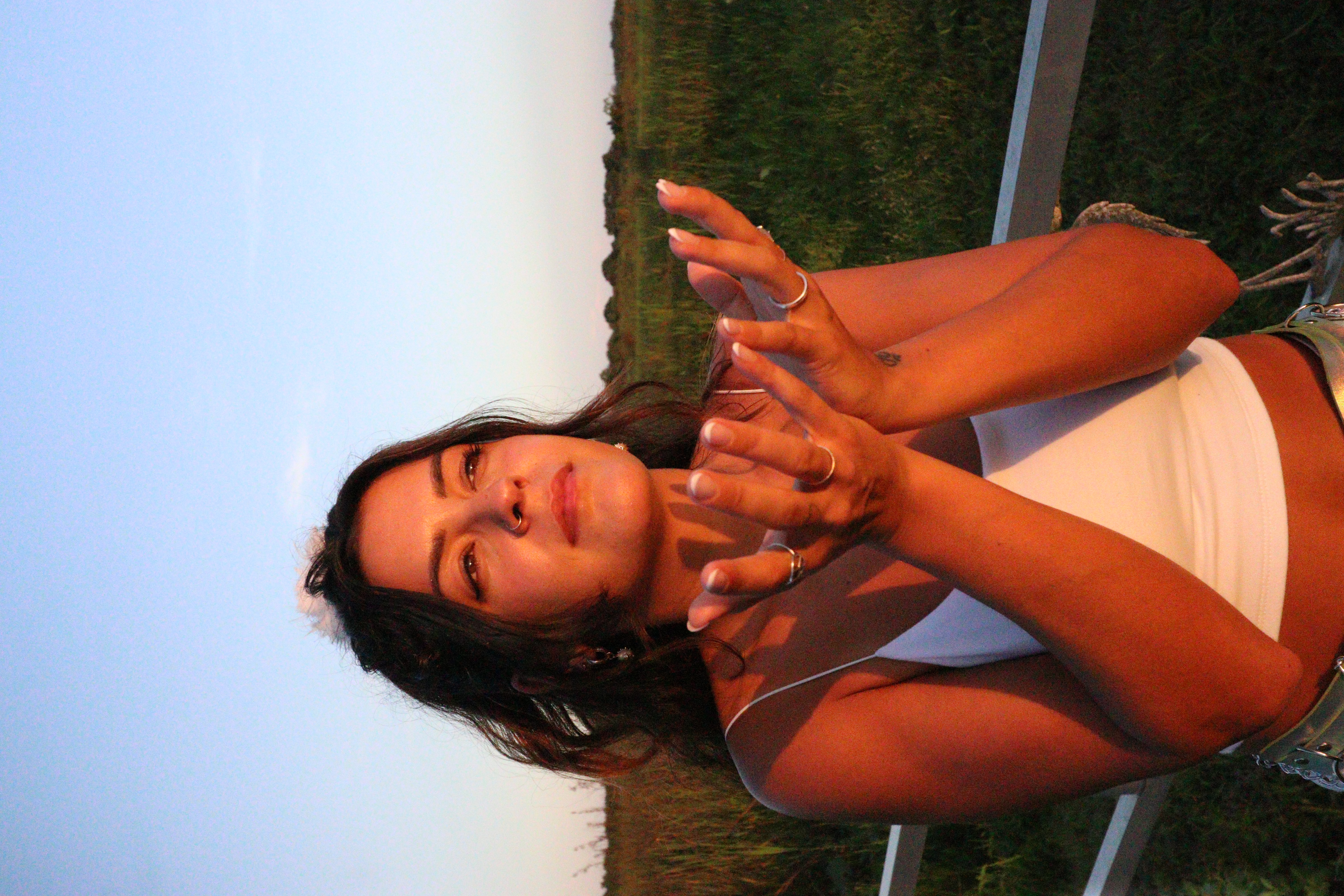 Madi at golden hour, eyes closed, hands open