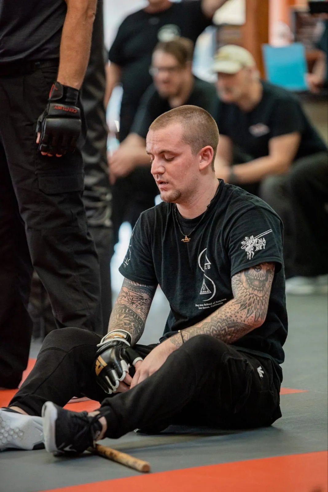 Practitioners watching from the mat during an Inayan System of Eskrima seminar
