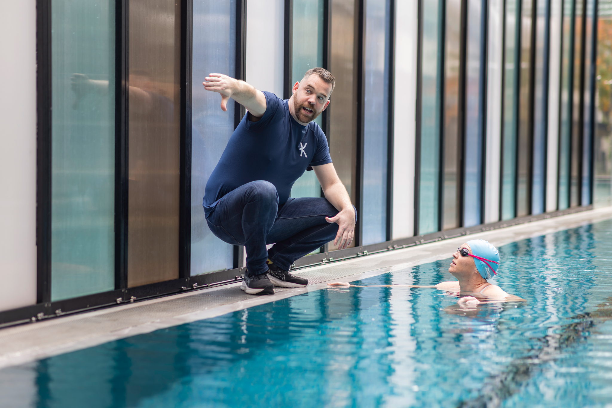 Coach Ray coaching a swimmer in the magnesium pool