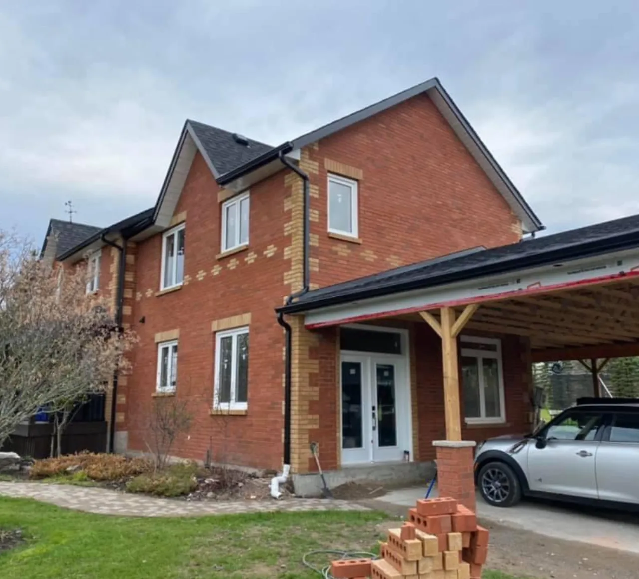 Two tone brick home with stone accents built by Strongback Contracting