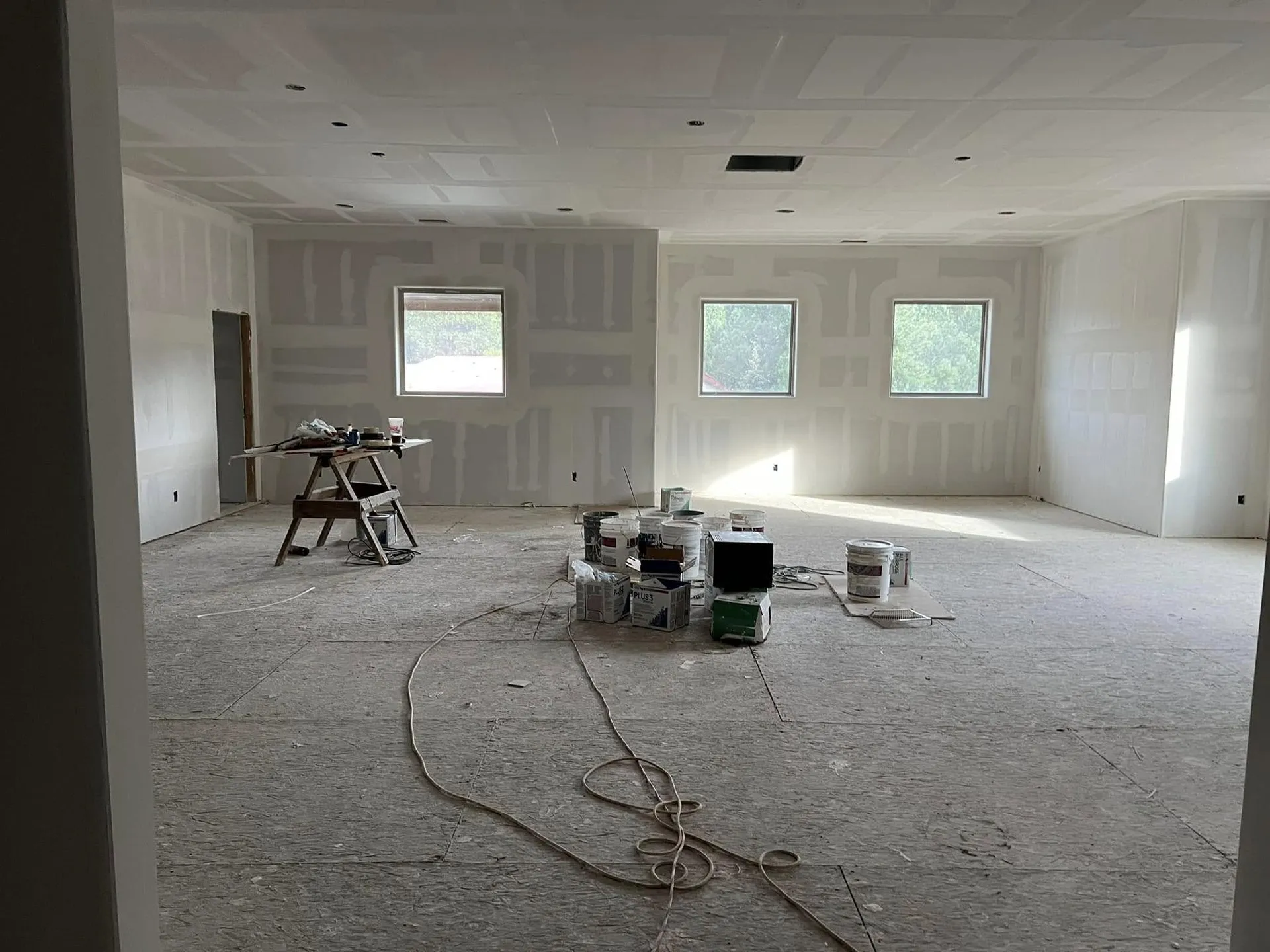 Open room with new drywall taped and mudded