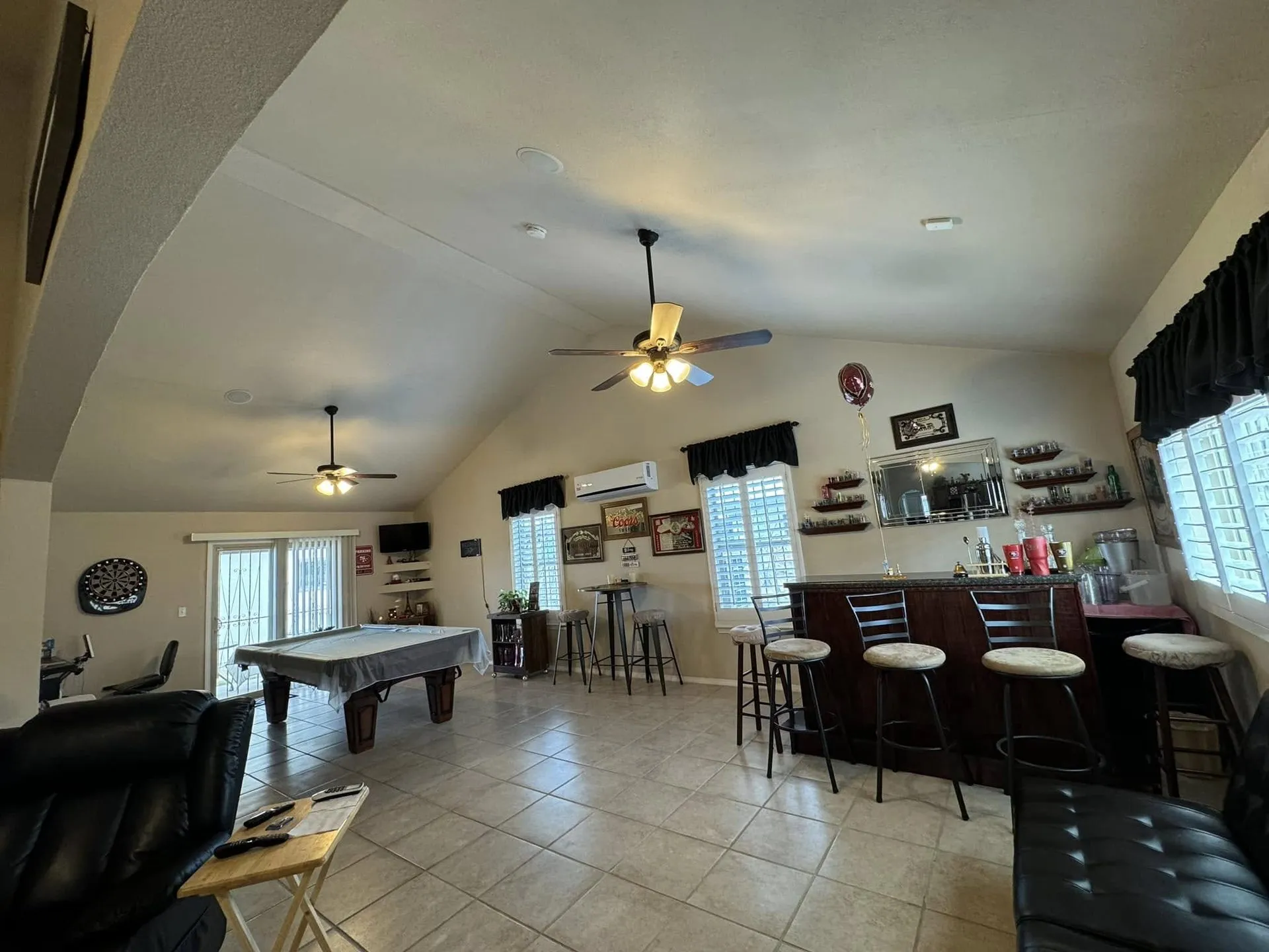 Game room with freshly painted walls and a vaulted ceiling