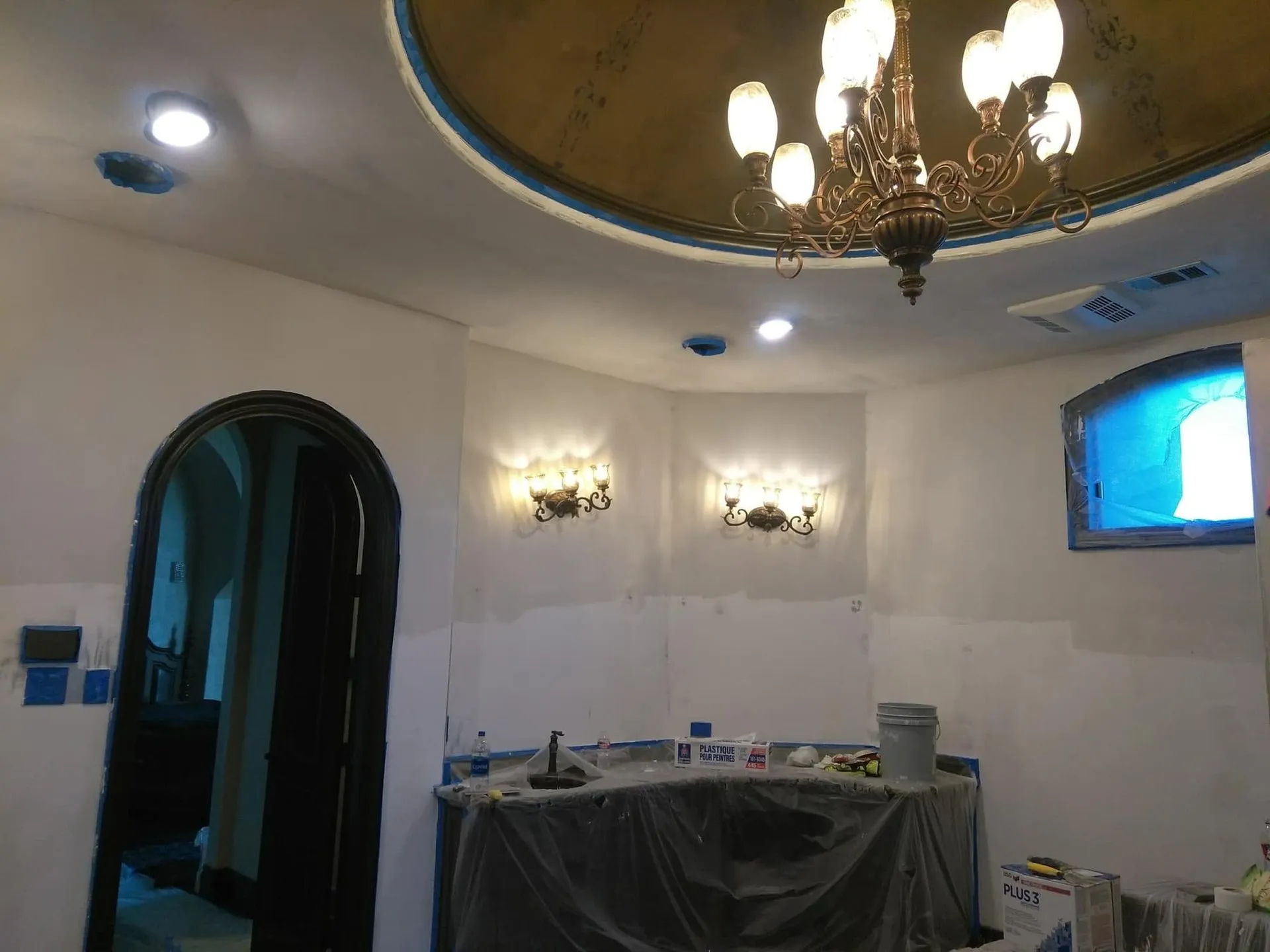 Room with a domed ceiling and chandelier during painting