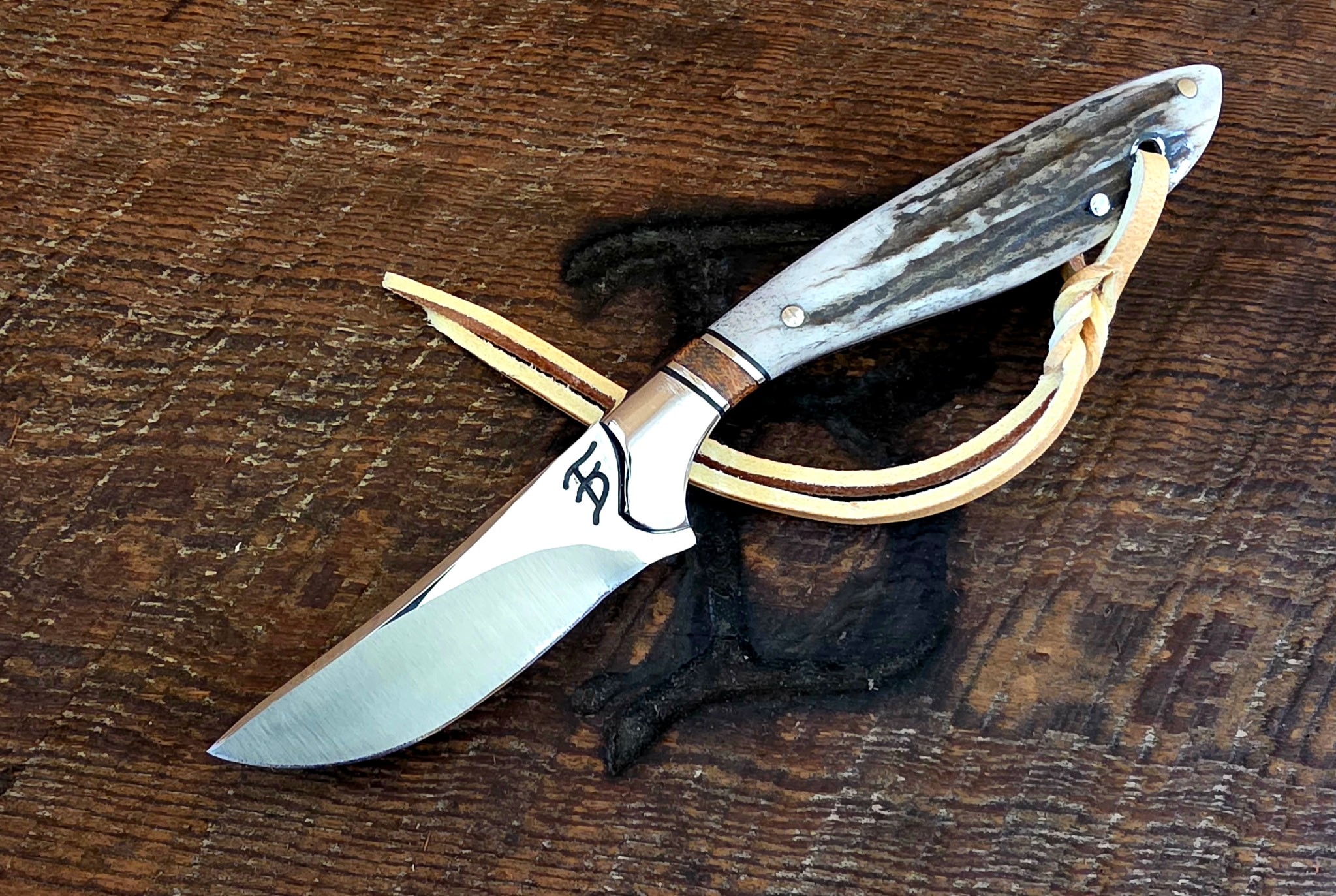 7 Inch Cowboy Hunter with 8670 Carbon Steel Blade - Brown Canvas Micarta and Stainless Inlay - Axis Deer Scales – Image 1
