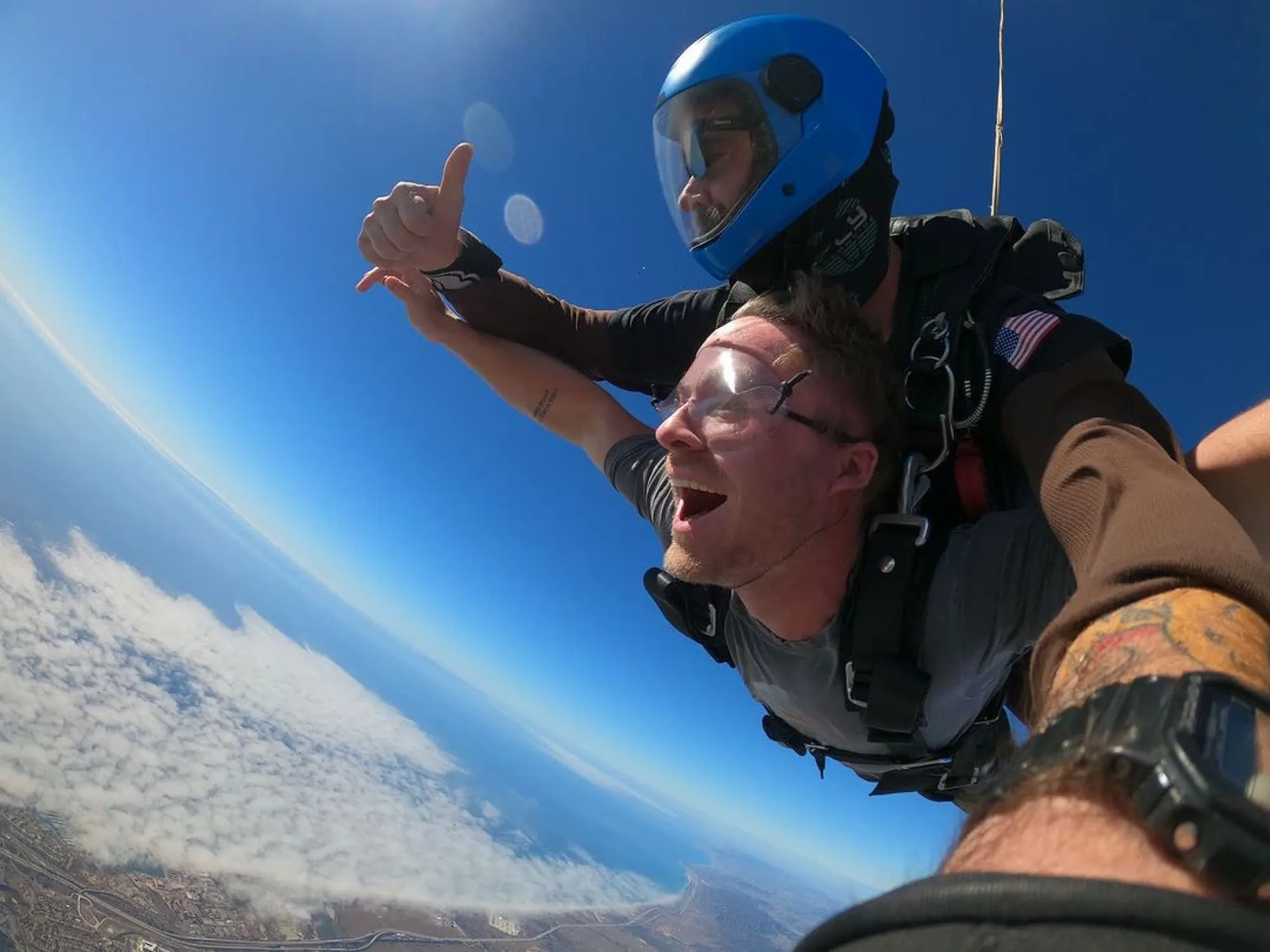 Member skydiving above the clouds