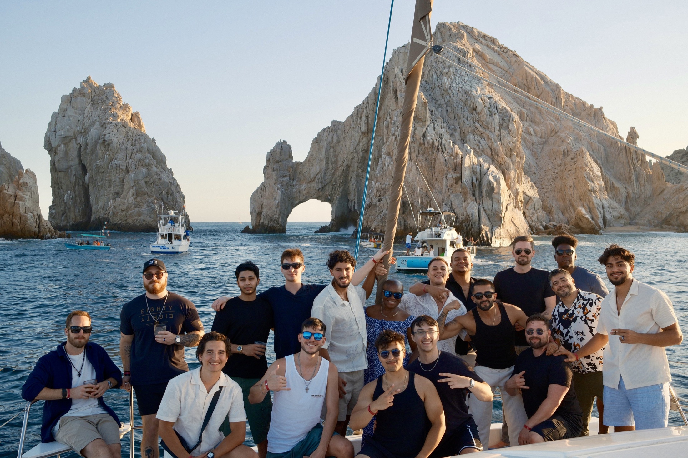 Sober Living Riches team together on a boat during the 2026 Cabo retreat