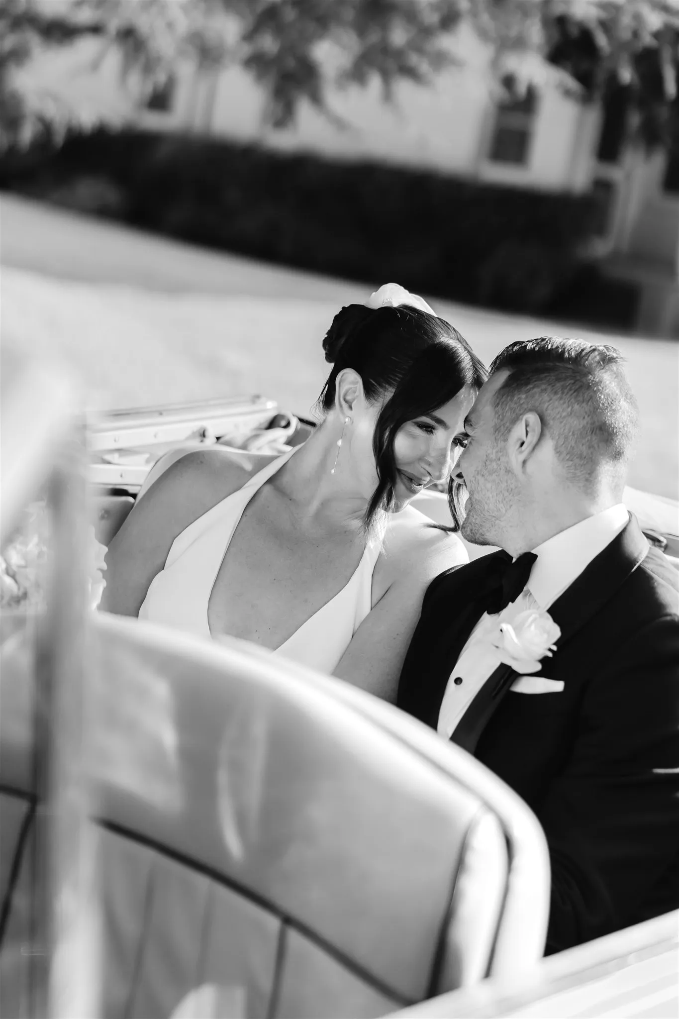 Couple in the back of a vintage car in black and white