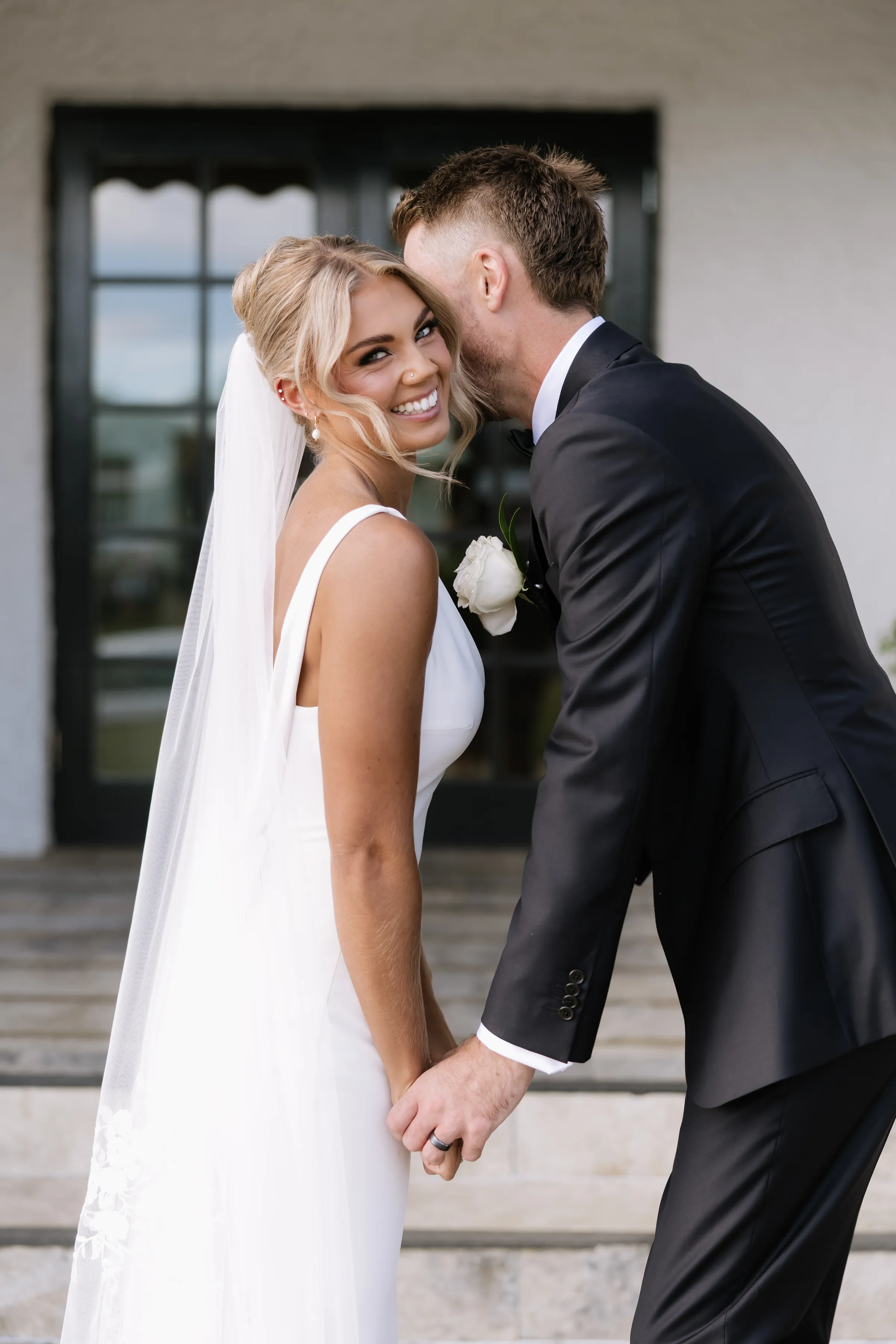 Bride and groom laughing close together