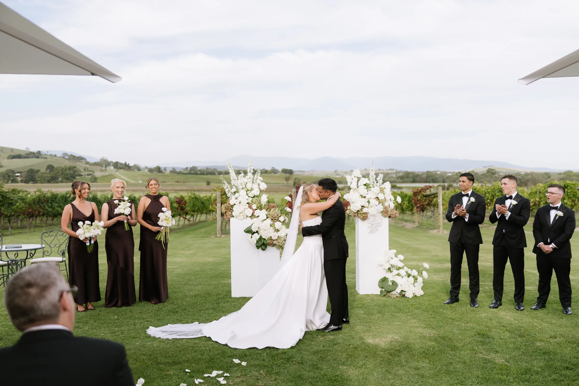 Ceremony on a lawn looking out over the vines