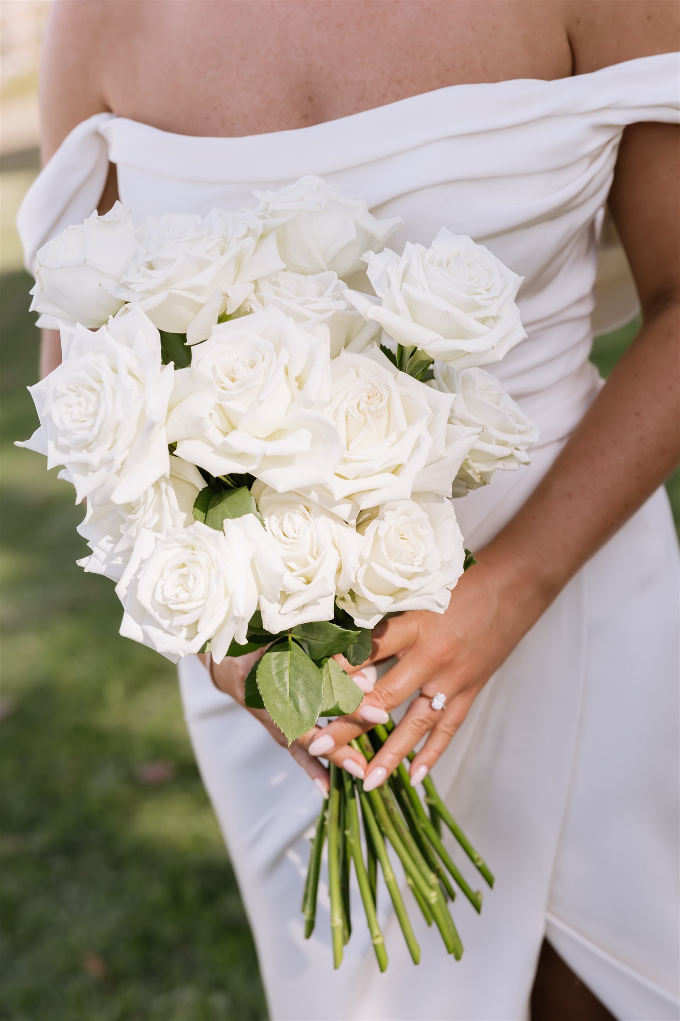 Bride holding a bouquet of white roses